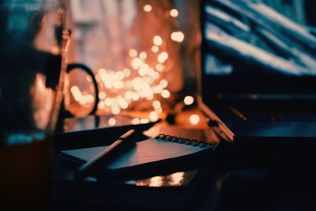 A notebook and laptop on a desk